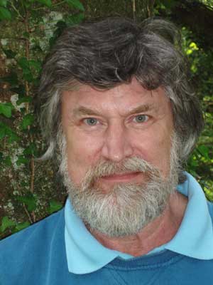 Portrait of Jack Angelo in blue shirt and sweater